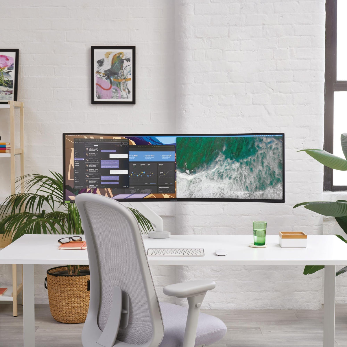 Flo X Monitor Arm carrying an ultrawide curved screen in an office