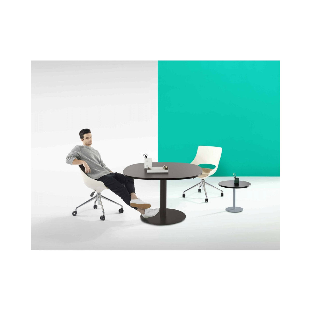 Disc Base table in black in a breakout setting