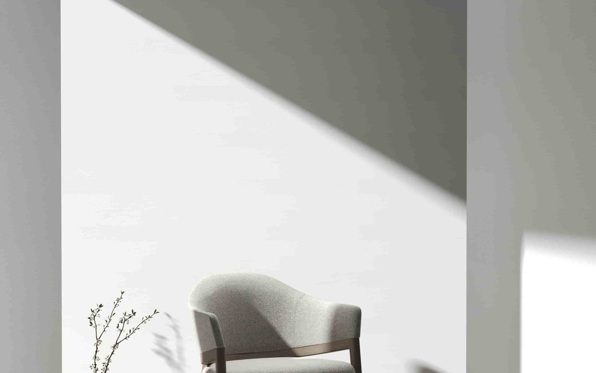 Hug Chair in tan leather beside a side table
