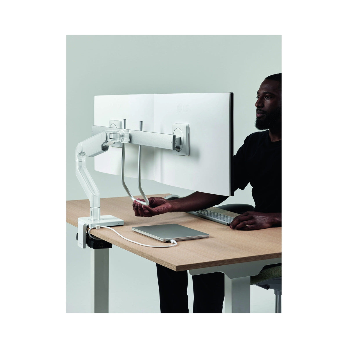 M8 Pro arm with two screens on a crossbar at a desk