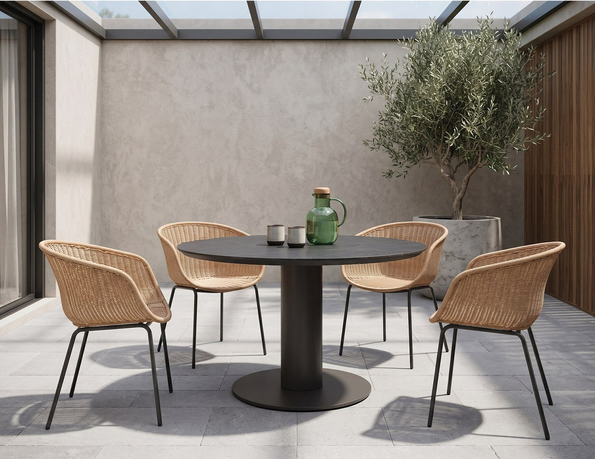 Loma Outdoor Round Dining Table in a styled interior