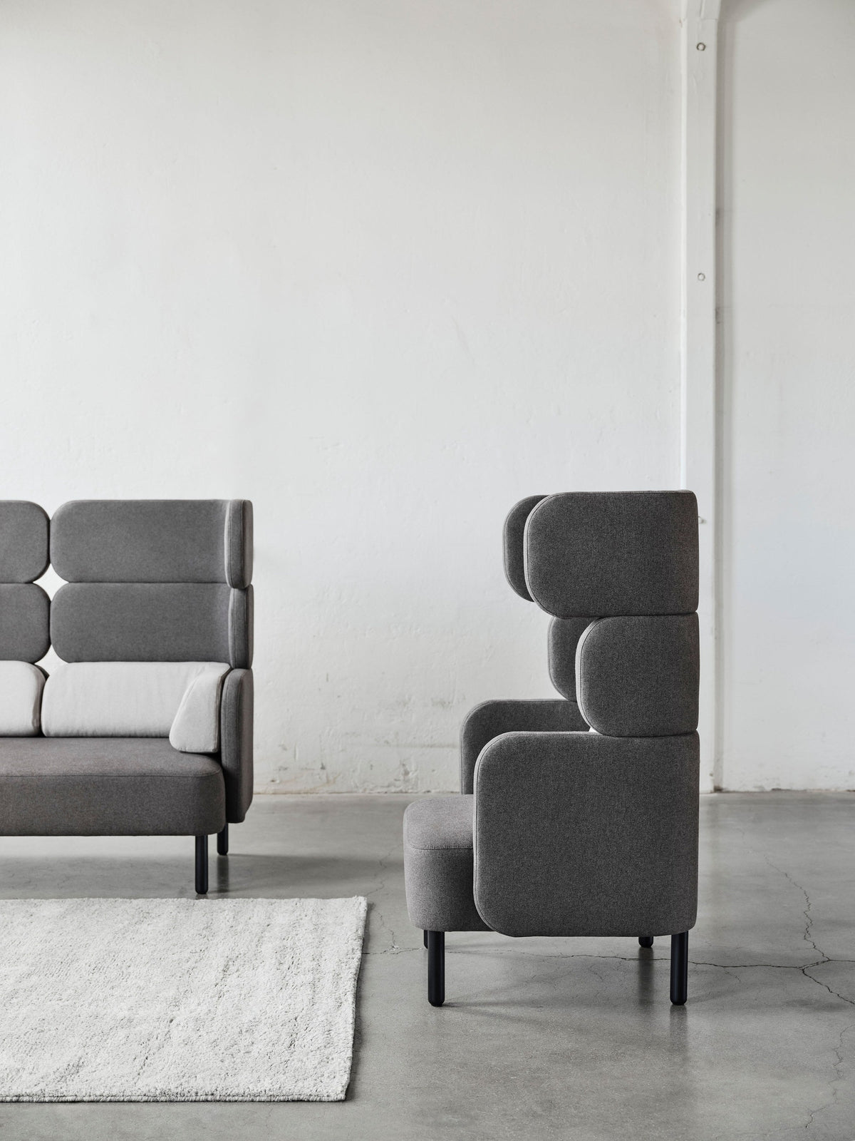 Story high-backed seating in a styled interior