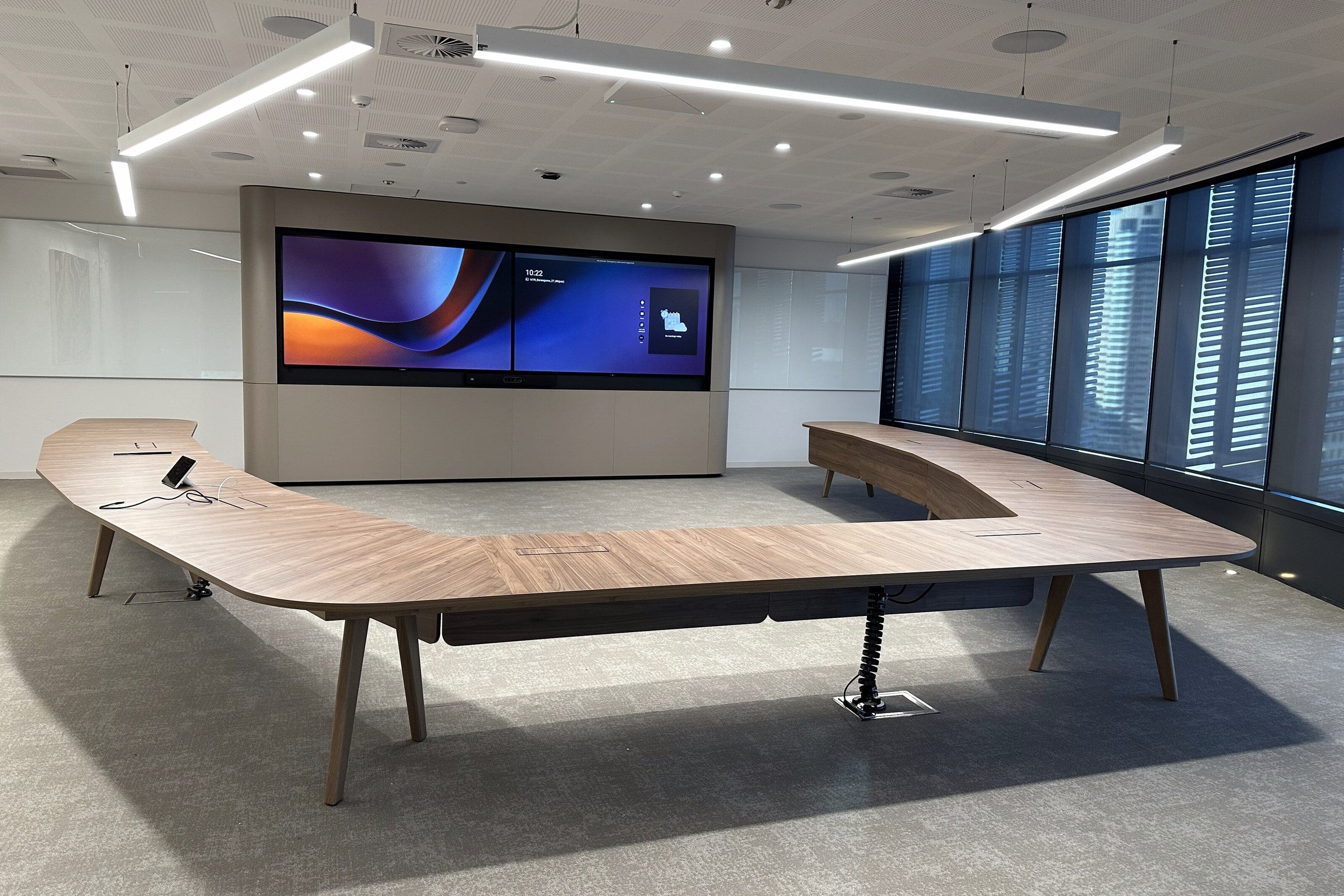 Bespoke horseshoe shaped boardroom table with meeting chairs around it in the TPG Telecom boardroom at Barangaroo, Sydney