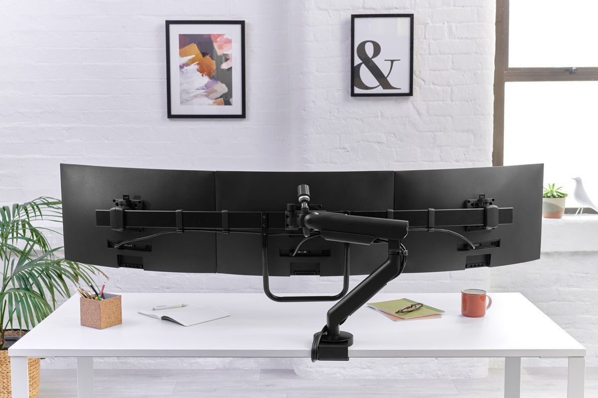 Flo X Multi Monitor Arm carrying three curved screens on a white desk