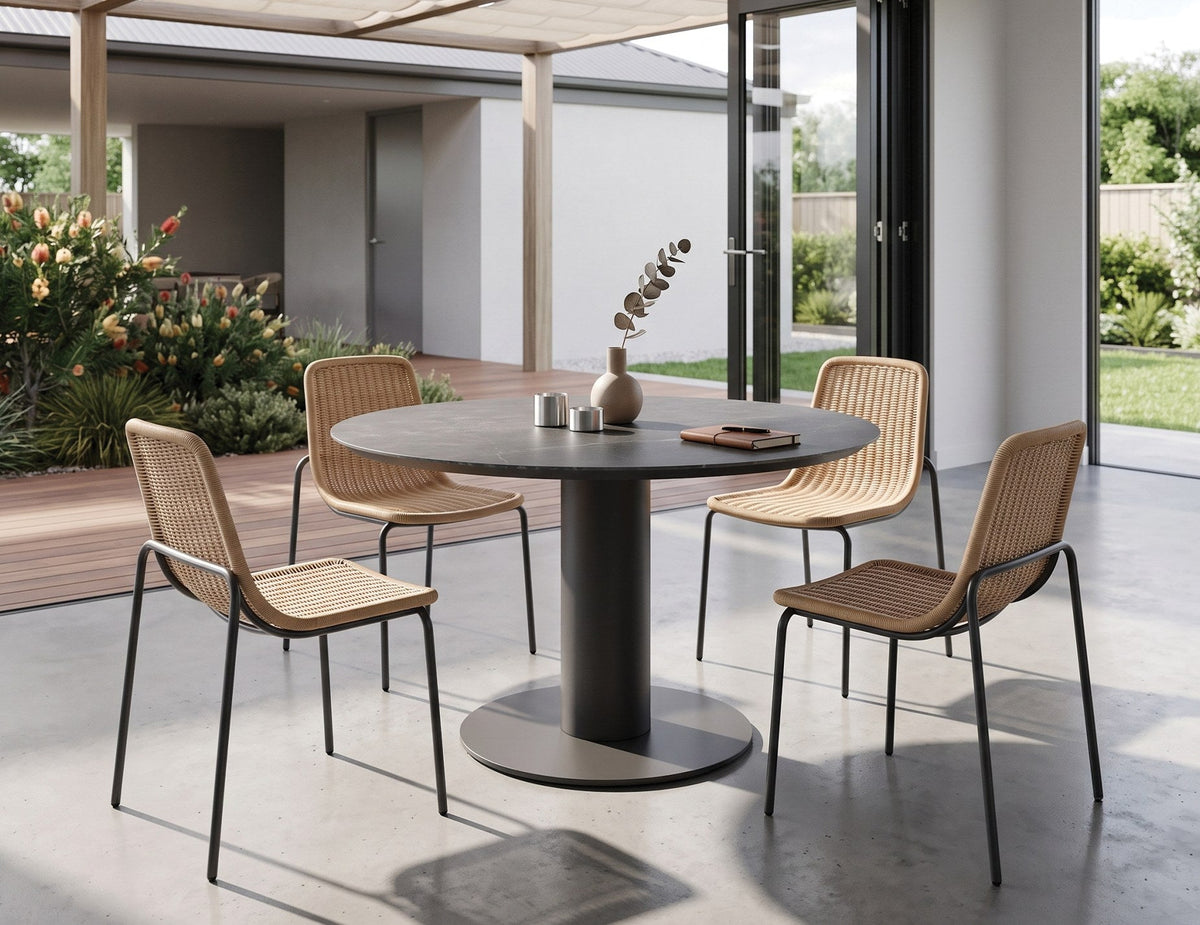 Loma Outdoor Round Dining Table in a styled interior