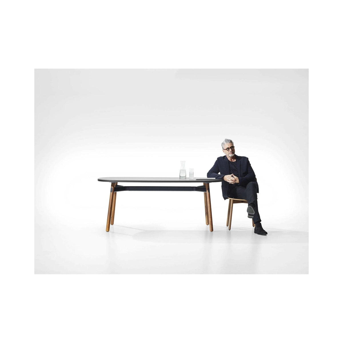 Okidoki table with a seated man