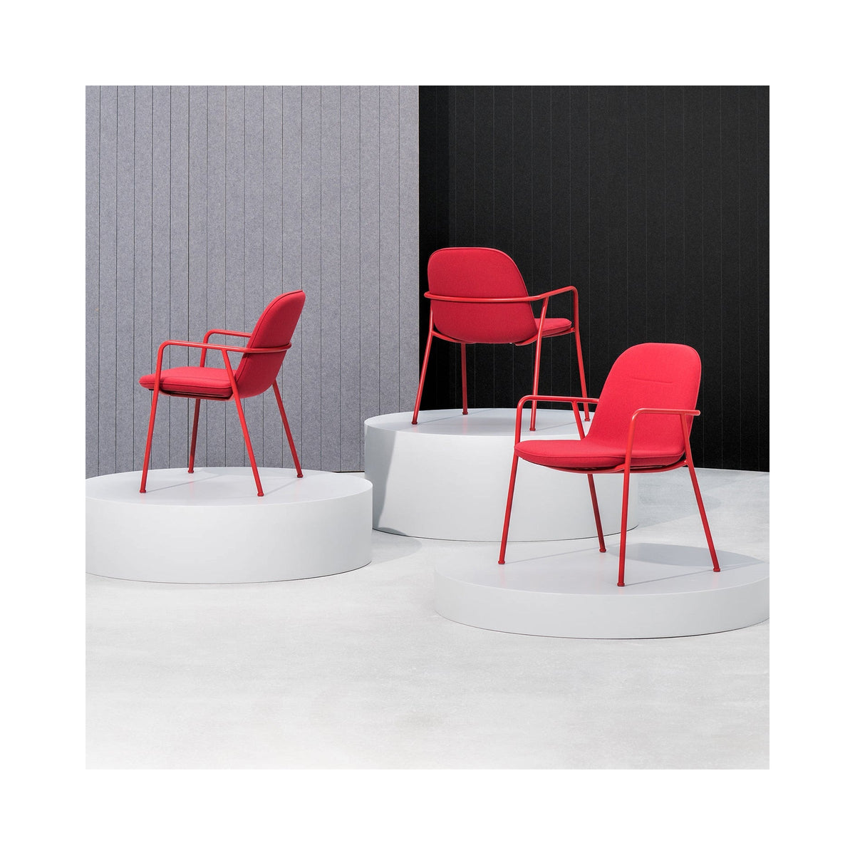 Three Reptile Mini chairs in red with red frames on display plinths